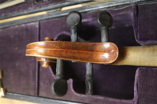 A cased violin and bows